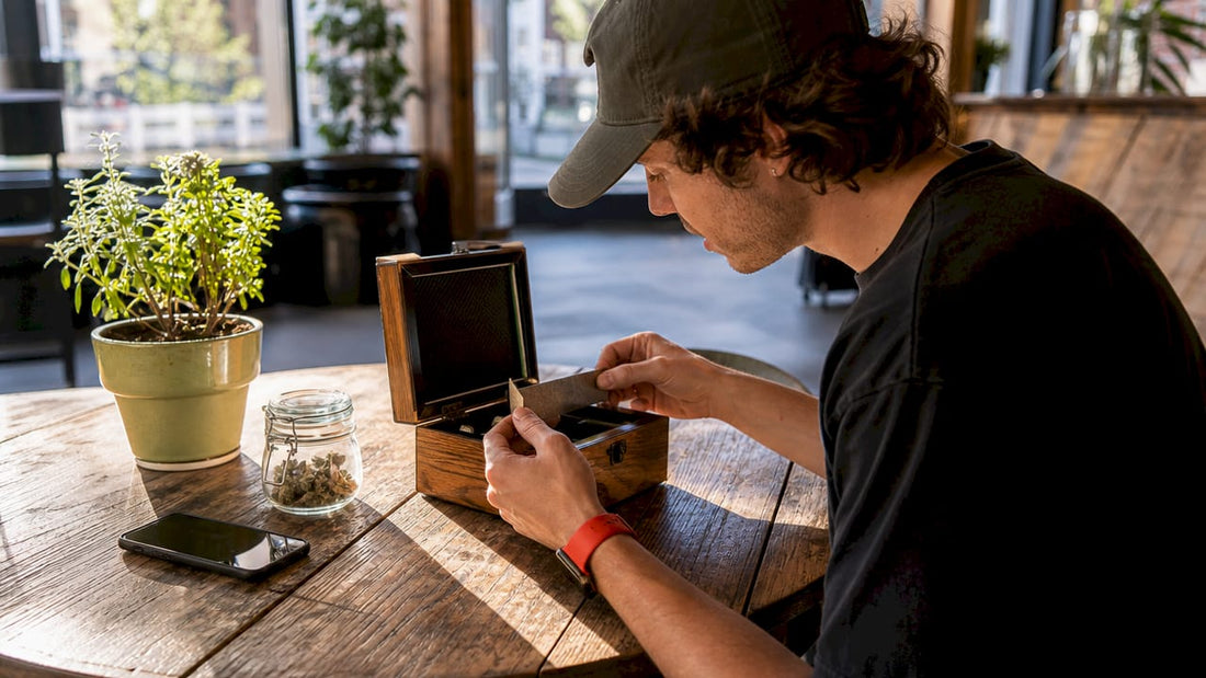 Cannabis user inspecting portable stash box