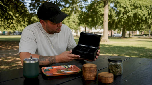 Man inspecting personalized weed gift box at home