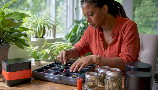 Woman organizing cannabis accessories in home room