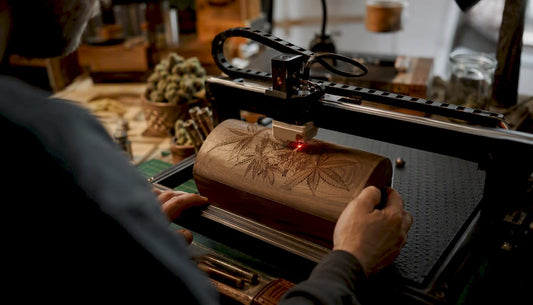 Hands laser-engraving wooden stash box lid