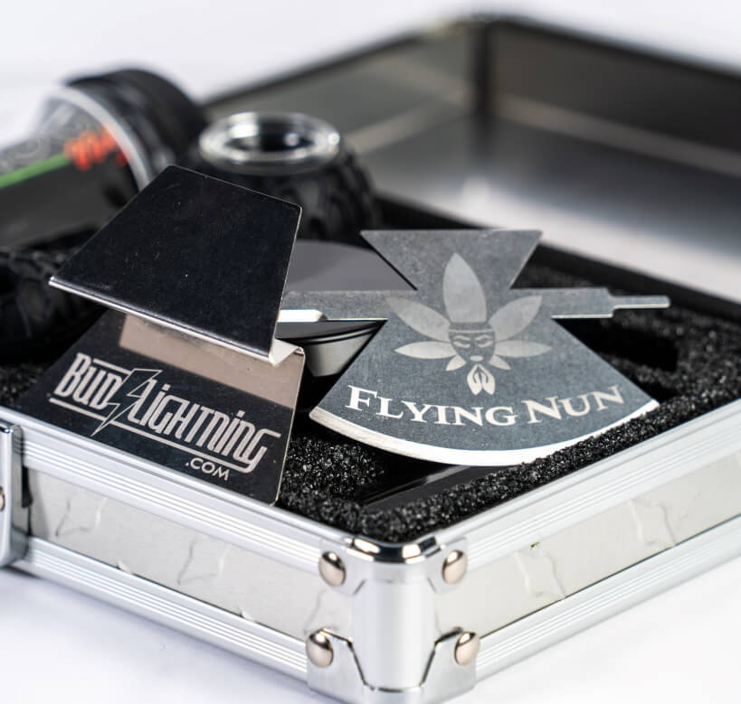 Flying Nun cannabis preparation tool included in a cannabis accessory kit with grinder and storage box.